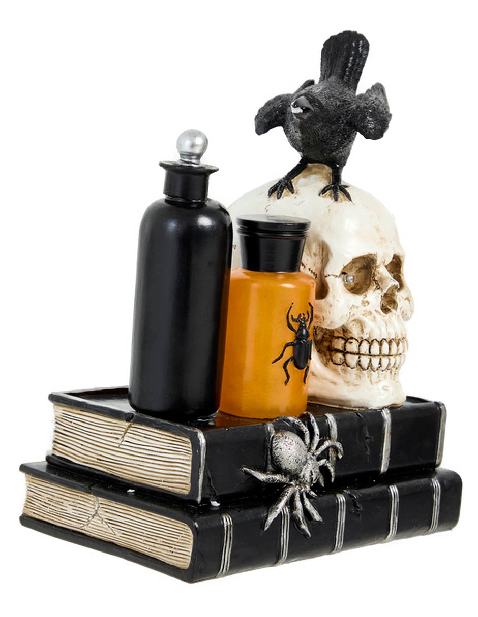 Figura decorativa de Halloween con forma de cráneo sobre libros 2