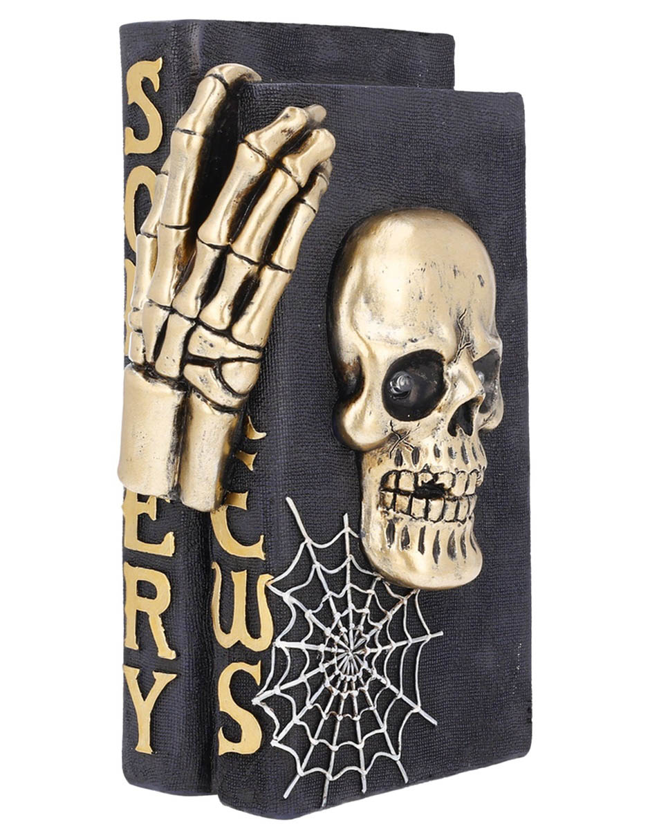 Figura decorativa de Halloween con forma de cráneo sobre libros 5
