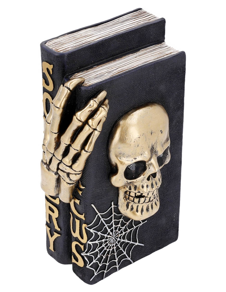 Figura decorativa de Halloween con forma de cráneo sobre libros 3