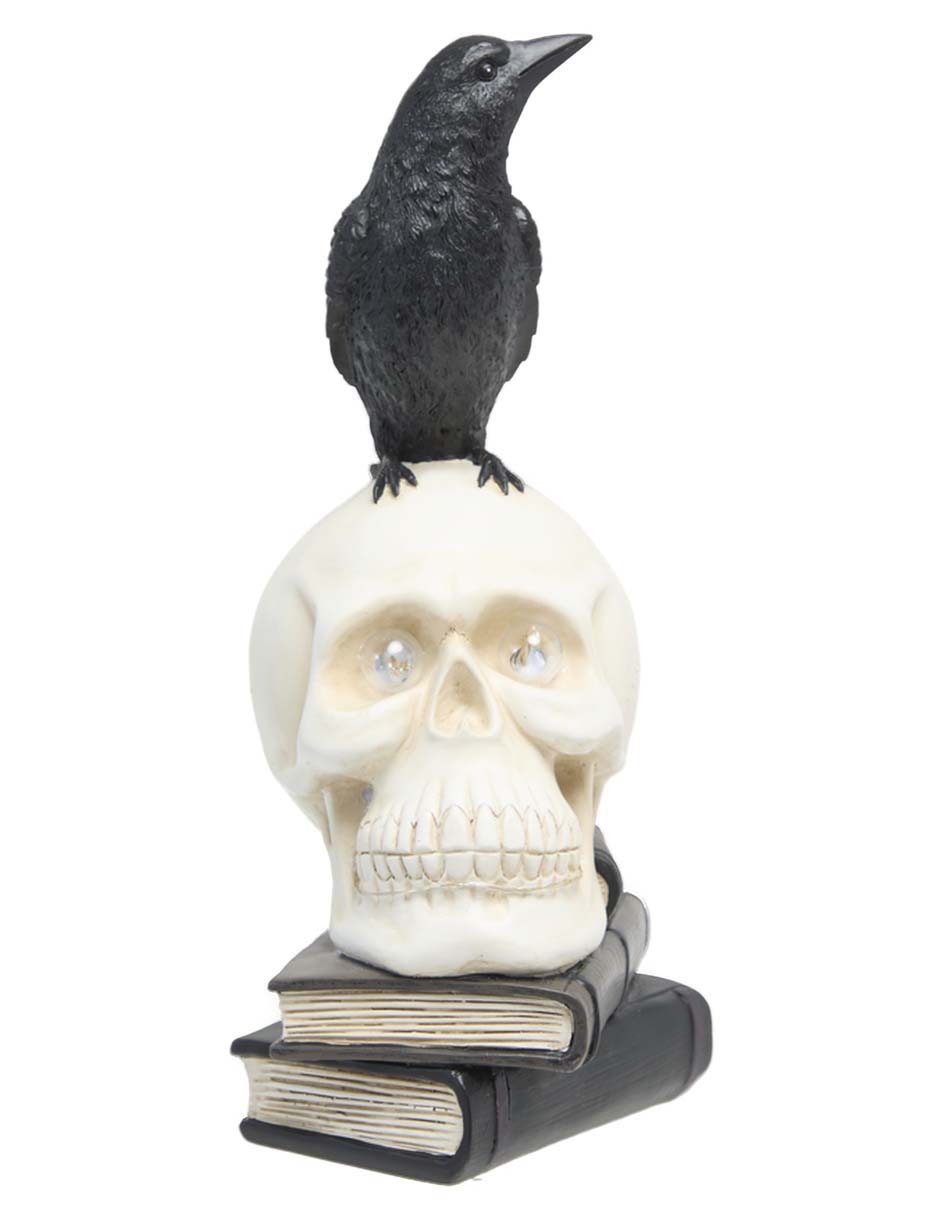 Figura decorativa de Halloween con forma de cráneo sobre libros 1