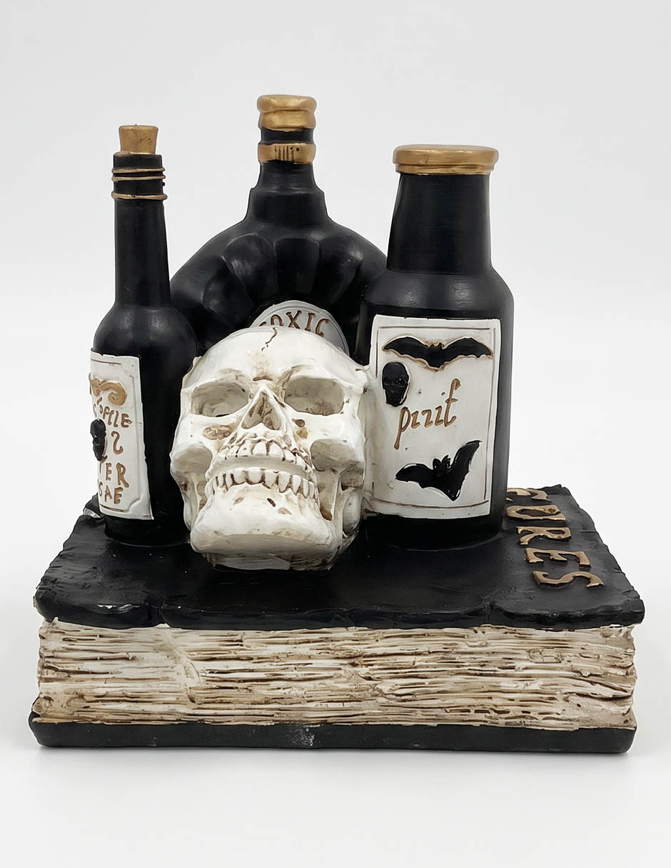 Figura decorativa de Día de muertos con forma cráneo sobre libro 1